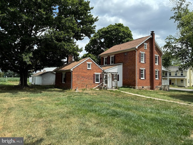 back of house with a yard