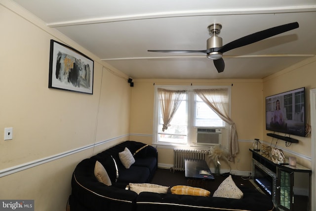 living room featuring ceiling fan, cooling unit, and radiator heating unit