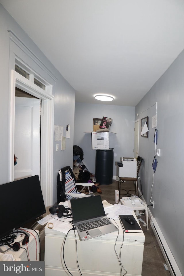 office featuring dark wood-type flooring and a baseboard heating unit