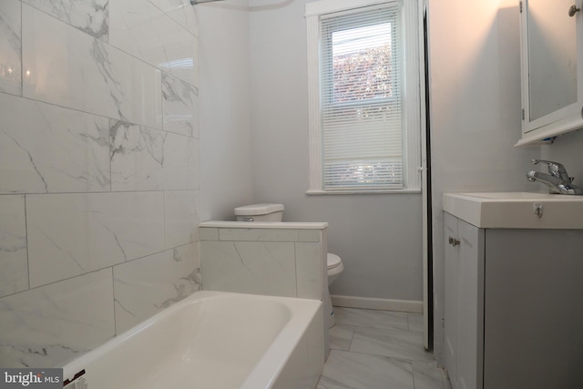 bathroom featuring vanity, a tub, and toilet