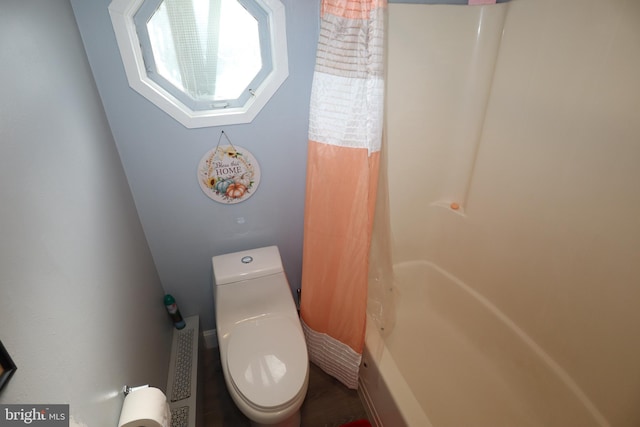 bathroom featuring toilet and walk in shower