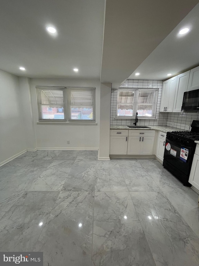 kitchen featuring tasteful backsplash, black appliances, sink, and white cabinets