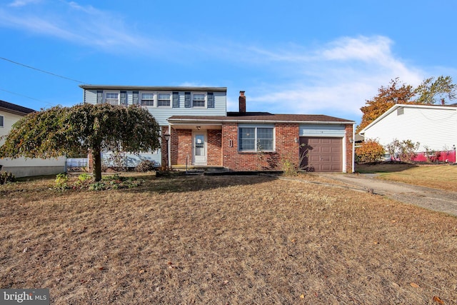 front of property with a front yard and a garage