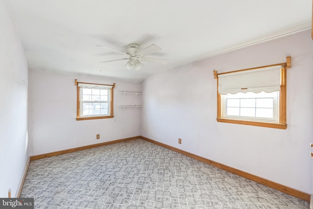 spare room with a wealth of natural light and ceiling fan