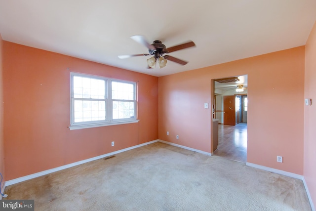 spare room with light carpet and ceiling fan