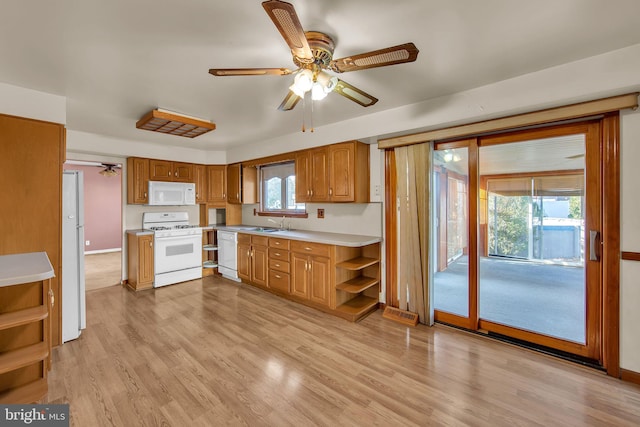 kitchen with white appliances, ceiling fan, light hardwood / wood-style flooring, and sink