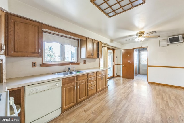 kitchen featuring ceiling fan, dishwasher, range, light hardwood / wood-style floors, and sink