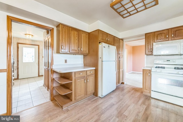 kitchen featuring light hardwood / wood-style floors and white appliances