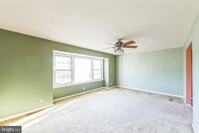 empty room featuring ceiling fan and carpet flooring