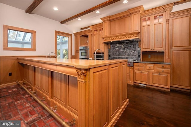 kitchen with oven, dark hardwood / wood-style floors, beamed ceiling, a skylight, and sink