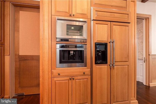 kitchen with dark hardwood / wood-style flooring and stainless steel double oven