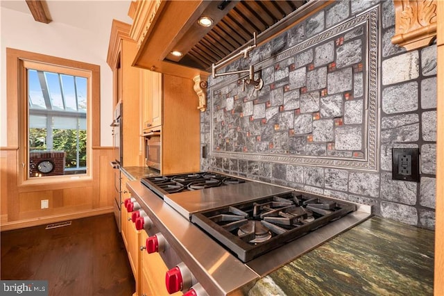 kitchen featuring beam ceiling, dark wood-type flooring, stainless steel gas cooktop, and custom exhaust hood