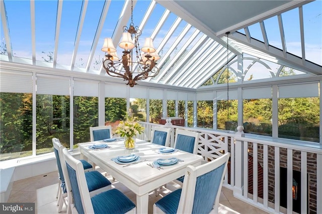 sunroom / solarium featuring a chandelier