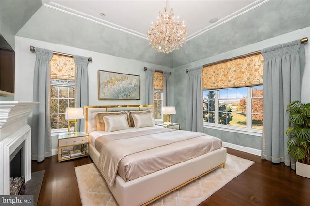 bedroom featuring a notable chandelier, dark hardwood / wood-style floors, and a tray ceiling