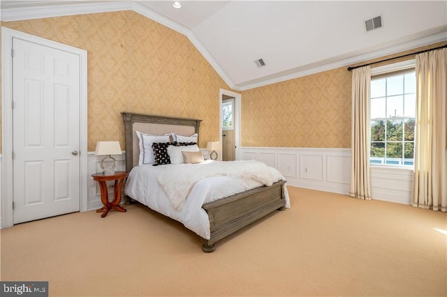 carpeted bedroom with ornamental molding and vaulted ceiling