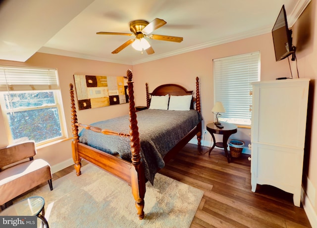 bedroom featuring ceiling fan, wood-type flooring, and ornamental molding