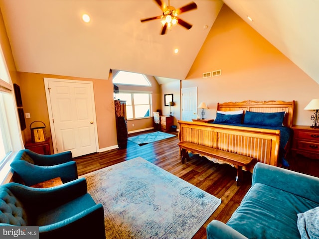 bedroom featuring dark hardwood / wood-style flooring, vaulted ceiling, and ceiling fan