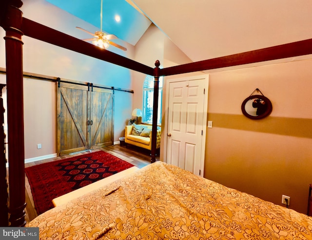 unfurnished bedroom featuring a barn door, ceiling fan, and lofted ceiling