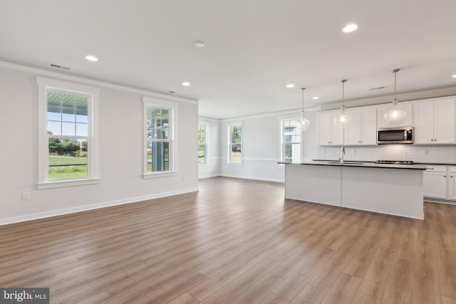 kitchen featuring white cabinetry, a wealth of natural light, and light wood-type flooring