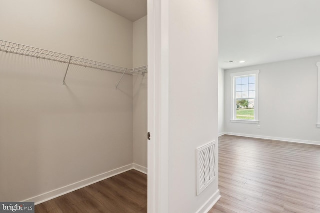 spacious closet featuring hardwood / wood-style flooring