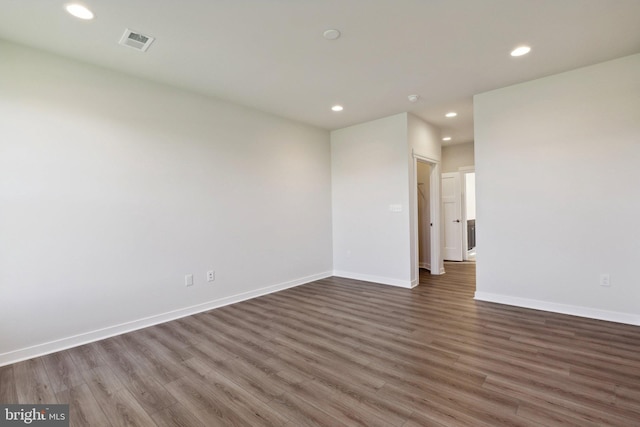 spare room featuring dark hardwood / wood-style flooring