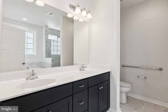 bathroom with vanity, toilet, and an enclosed shower