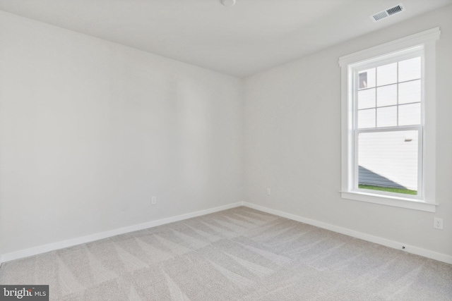 carpeted spare room featuring a healthy amount of sunlight