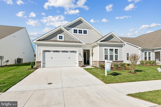 craftsman-style home featuring a front lawn and central air condition unit