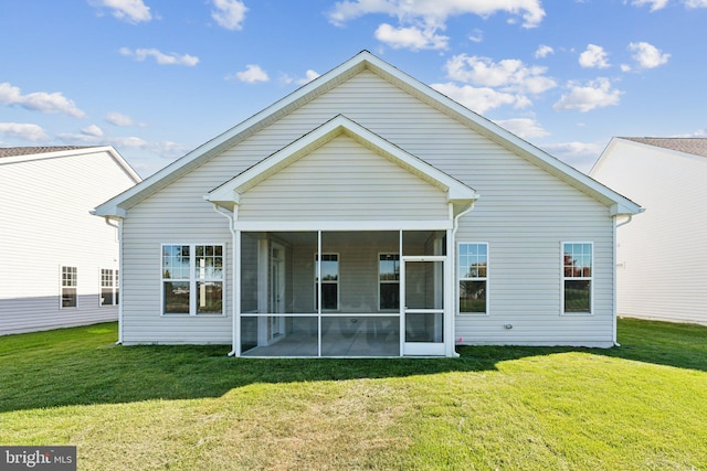 back of house featuring a yard and a sunroom