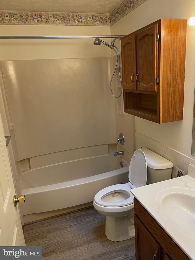 full bathroom with vanity, hardwood / wood-style flooring, toilet, and shower / bath combination