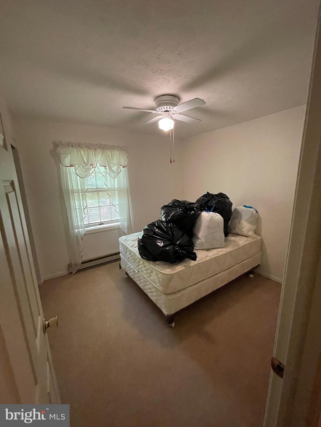 carpeted bedroom with a textured ceiling, a baseboard radiator, and ceiling fan