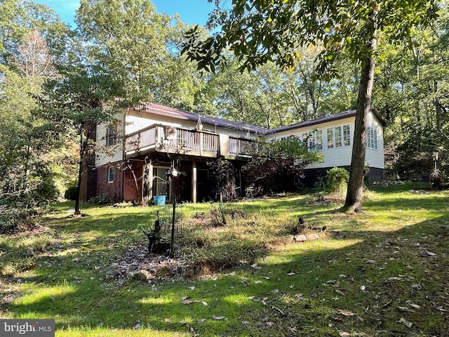 rear view of property featuring a lawn