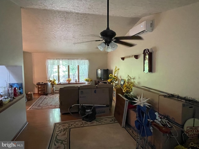 living room featuring a textured ceiling, a wall mounted air conditioner, and hardwood / wood-style flooring