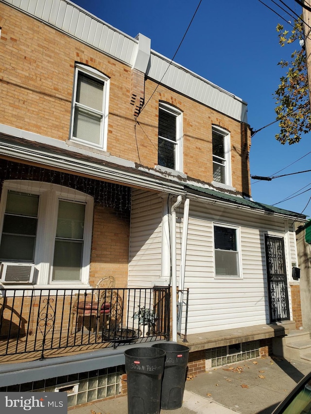 back of property featuring covered porch