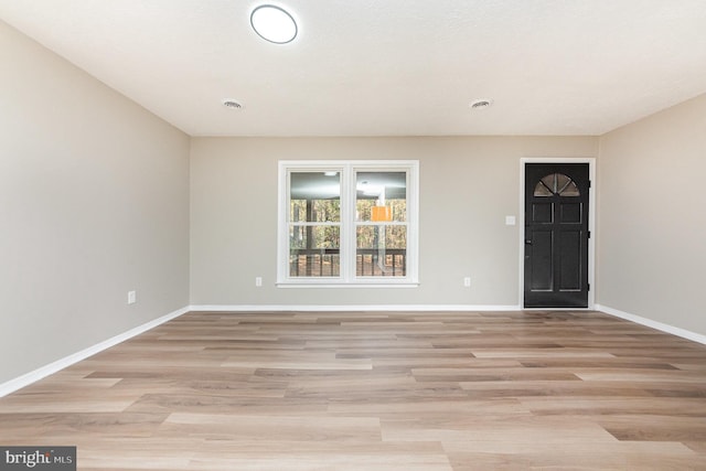 spare room featuring light wood-type flooring