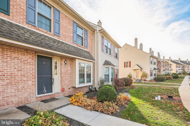 view of exterior entry with a yard