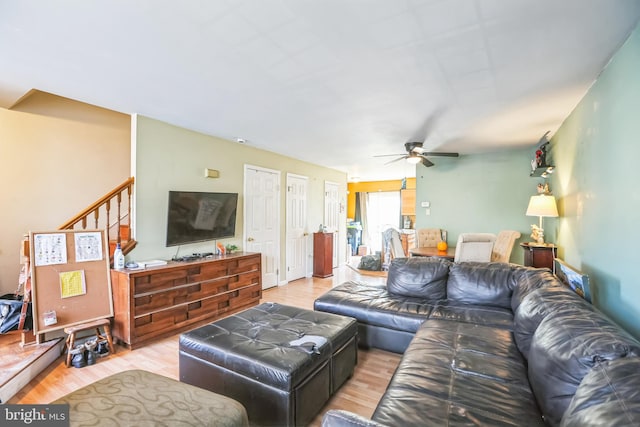 living room with ceiling fan and light hardwood / wood-style floors