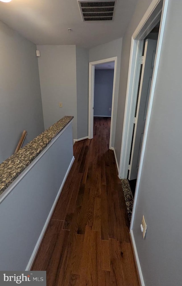 corridor with dark wood-type flooring