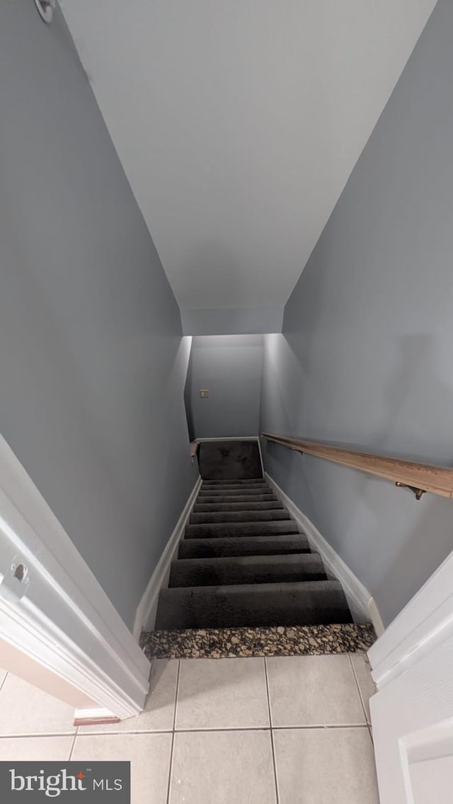 stairs featuring tile patterned flooring