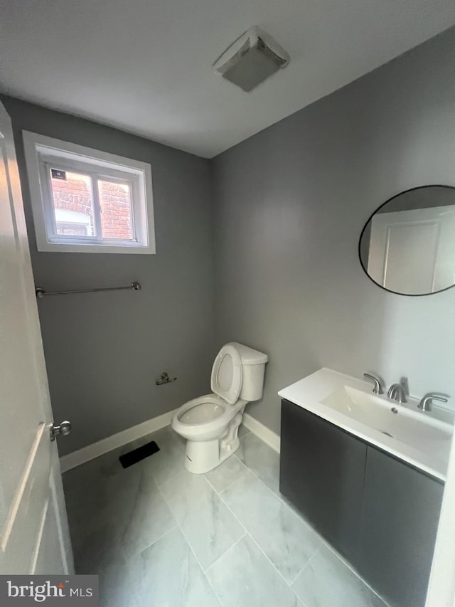 444 E 28th St, Baltimore, MD 21218 - half bath with vanity, visible vents, marble finish floor, toilet, and baseboards