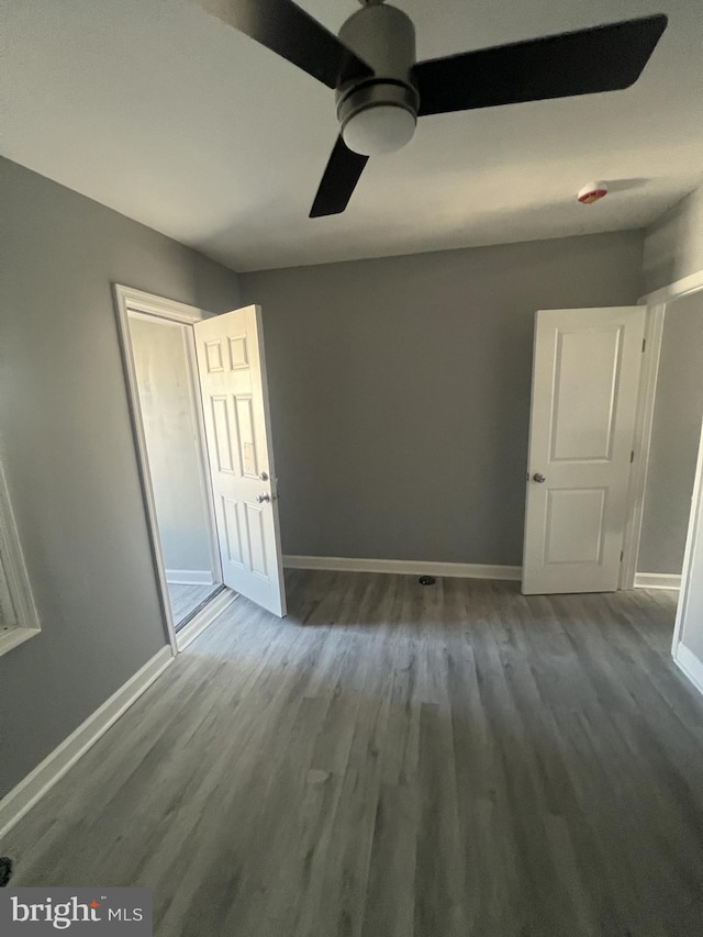 empty room featuring ceiling fan and hardwood / wood-style floors