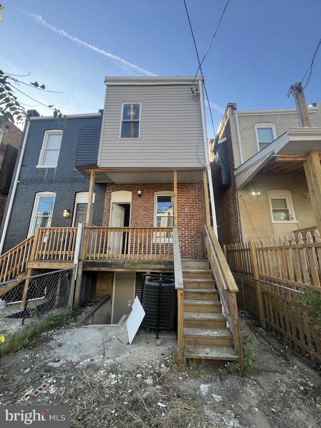 444 E 28th St, Baltimore, MD 21218 - back of house featuring brick siding, central AC unit, fence, and stairway