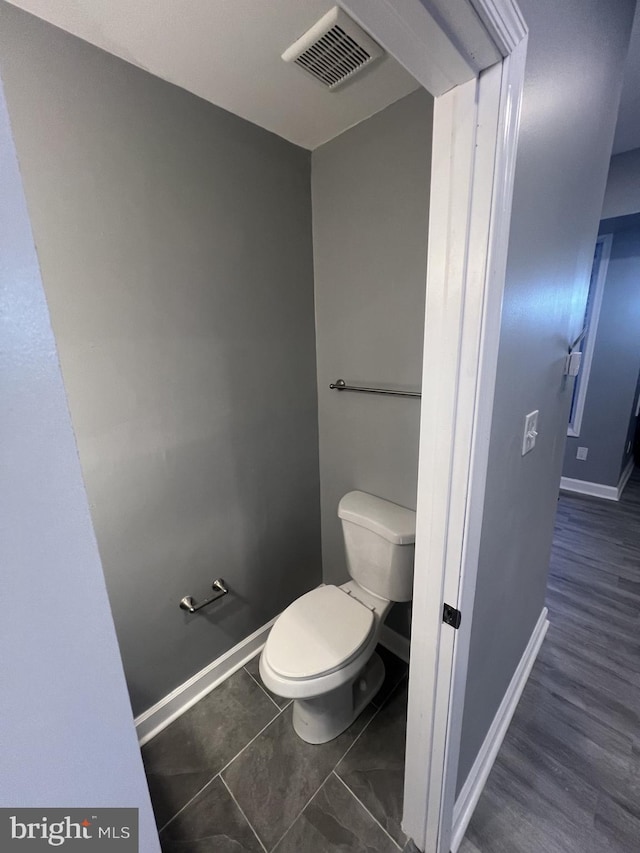 bathroom with wood-type flooring and toilet