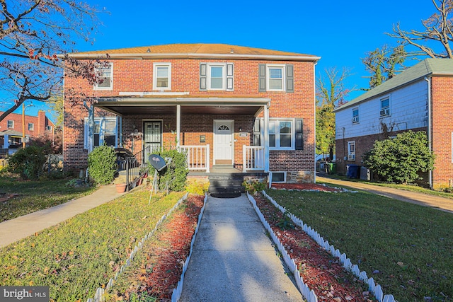 view of property featuring a front yard, central AC, and covered porch