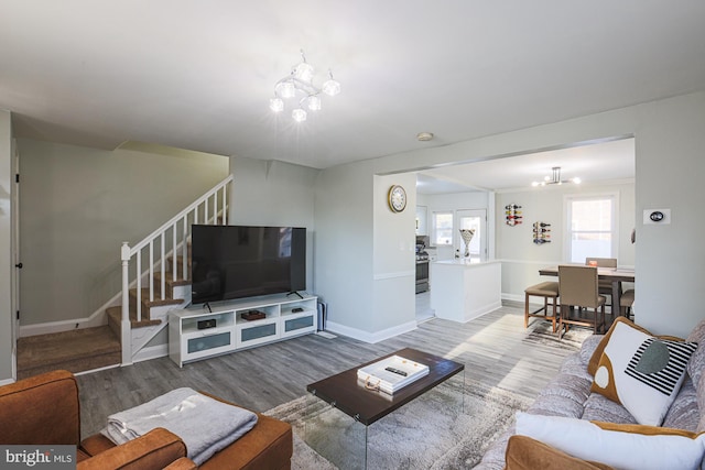 living room featuring hardwood / wood-style flooring and a notable chandelier