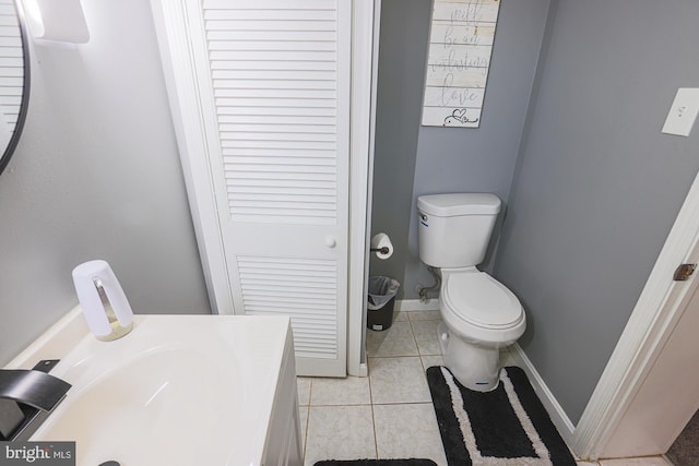 bathroom featuring toilet, vanity, and tile patterned floors