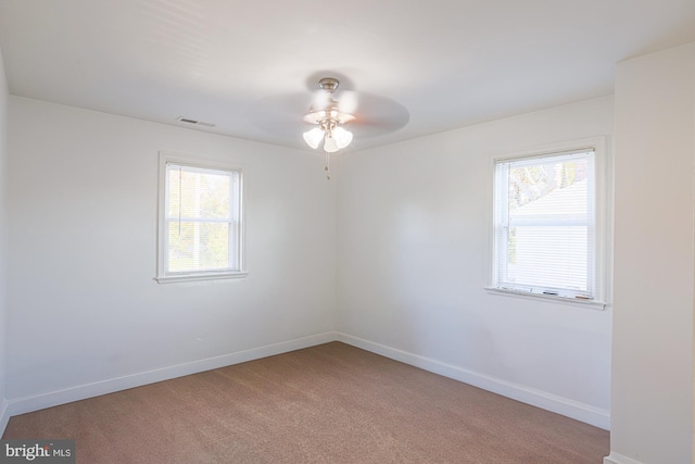 spare room featuring carpet and ceiling fan