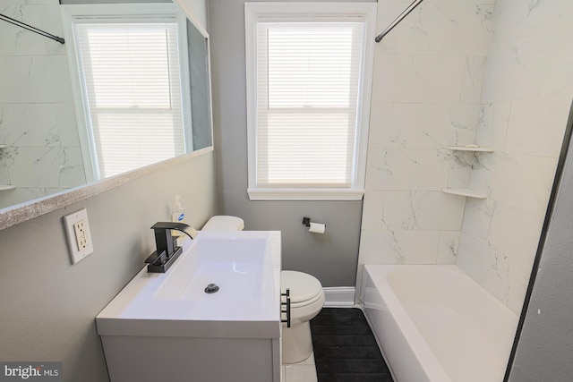 full bathroom featuring toilet, vanity, and plenty of natural light