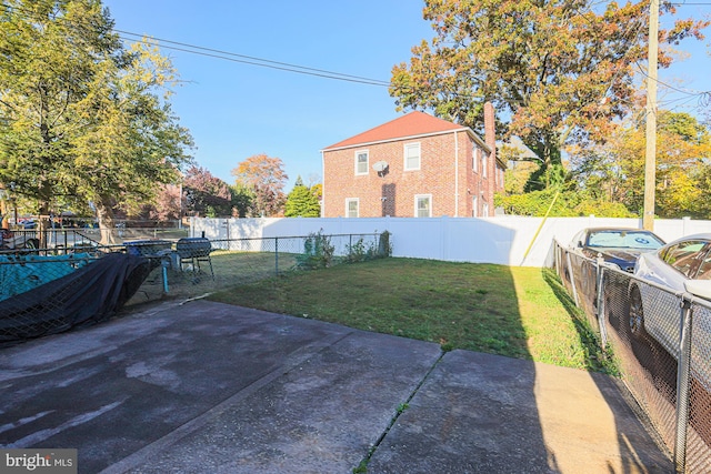 view of yard featuring a playground and a patio area