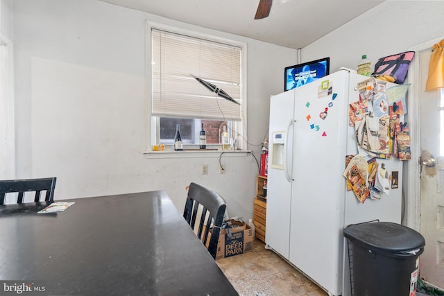 kitchen with white refrigerator with ice dispenser, white cabinetry, and ceiling fan